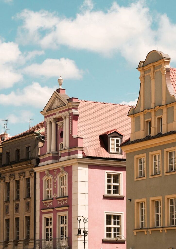 Colorful historic facades in Poznań, Poland under a bright blue sky.